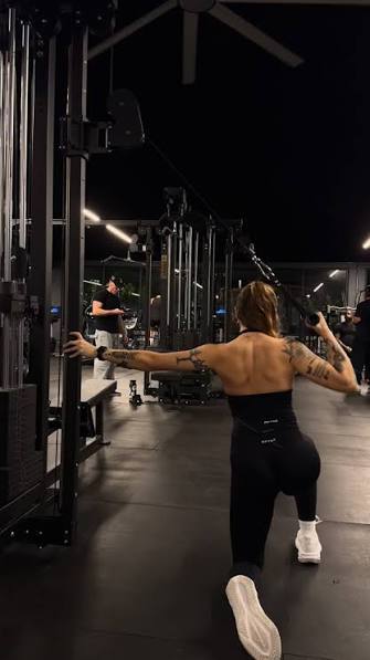 Coach guiding proper lifting technique